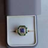 Exquisite 1.15ct Tanzanite ring in 18k yellow gold, surrounded by diamonds and green tsavorites, UK size M